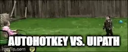Two kids in a grassy yard, one swinging a stick at a ball, with the caption AutoHotkey vs. UiPath in white text at the bottom.